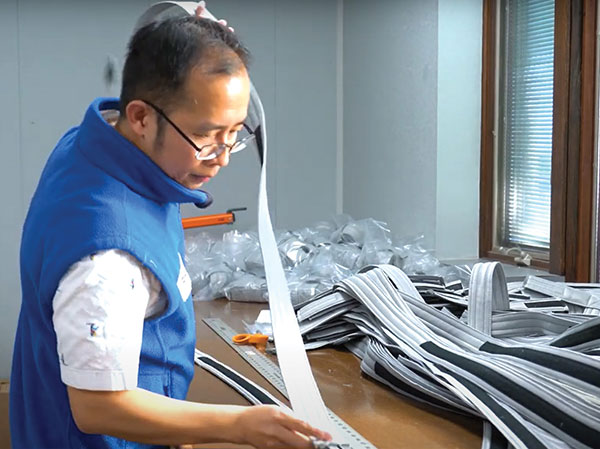 LJ staff member measuring a piece of a product