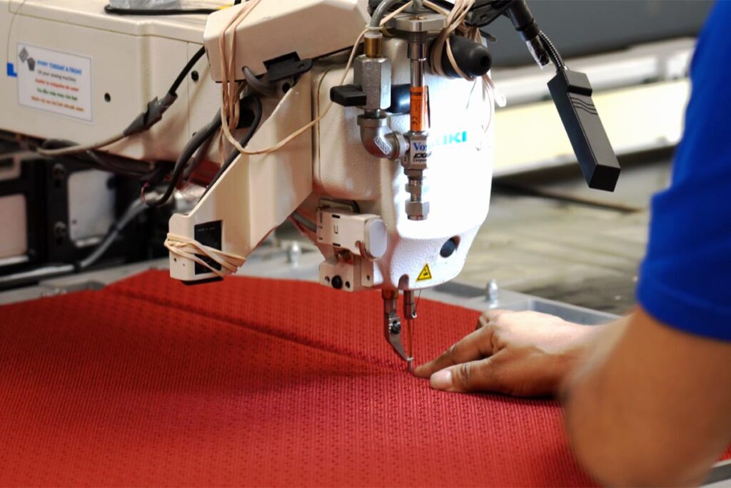 Talented member of LJ Design & Manufacturing's workforce sewing a product for a client